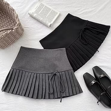 Юбка мини с плиссированным низом и бантом сбоку. Снизу есть шортики