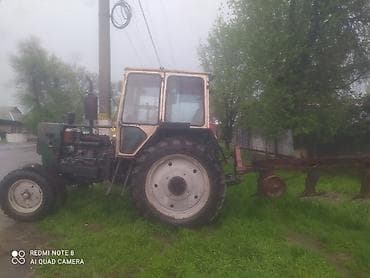 Трактор колесный с кабиной + навесной плуг Описание: - Универсальный