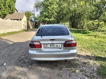керме тоо: Mazda 626: 1999 г., 1.8 л, Кол менен иштөөчү, Бензин, Седан — 4
