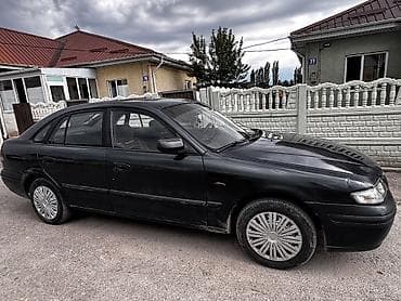 Унаа сатуу: Mazda 626: 1997 г., 1.8 л, Кол менен иштөөчү, Бензин, Хетчбек — 1