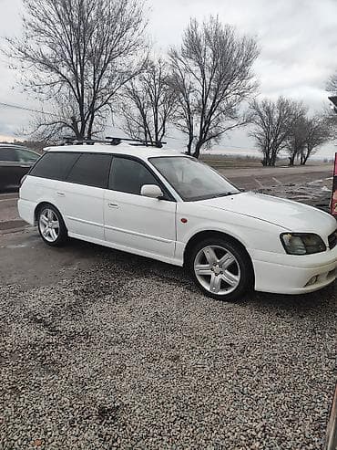 талас авто: Белый универсал с рейлингами на крыше. Компактный кузов, пять дверей — 1