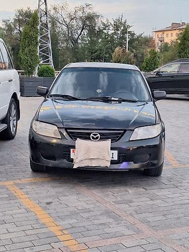 mazda 626 1998: Mazda 323: 2002 г., 1.3 л, Механика, Бензин, Универсал — 1