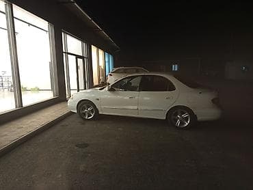 Седан белого цвета, 4 двери. Кузов классической формы с плавными