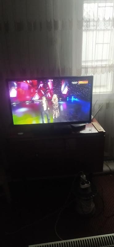 Телевизор LED, диагональ экрана примерно 32–40". Плоская панель