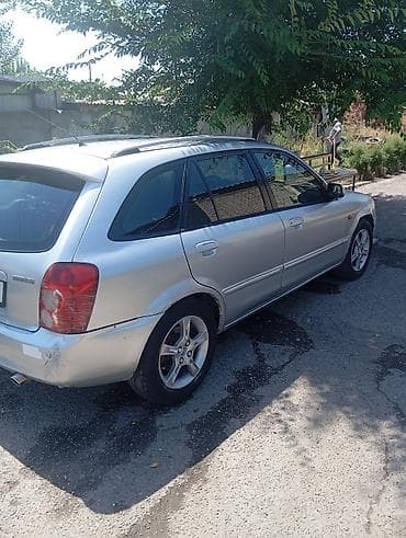 домкрат на фит: Mazda Familia: 2002 г., 1.6 л, Механика, Бензин, Универсал — 2