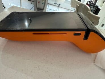 купить оборудование для ремонта телефонов: Портативный POS-терминал в оранжево-черном корпусе. Устройство — 4