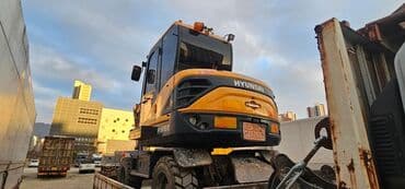 экскаваторы работы: Колесный экскаватор Hyundai, выполненный в желтом и черном цветах — 3