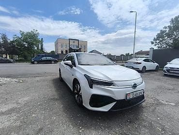 электромобиль станции зарядки: Электромобиль GAC Aion S, белый седан. Ключевые особенности: - — 2