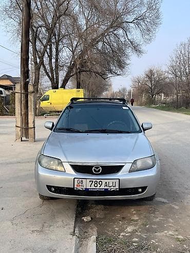 наклейка на машина: Mazda 323: 2003 г., 1.6 л, Ручные, Бензин, Седан — 3