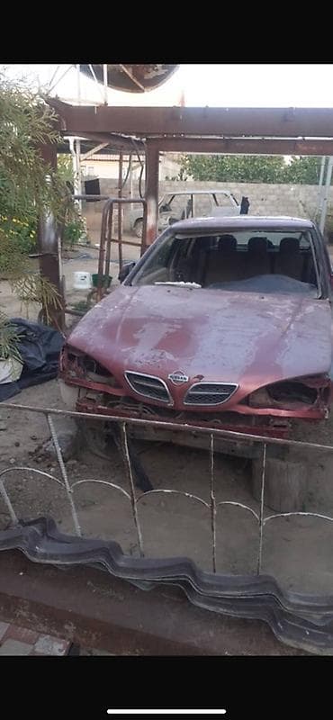 aion v plus: Nissan Almera (седан), красный цвет, кузов P11. Описание: - — 1