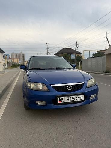 Унаа: Mazda 323: 2003 г., 1.6 л, Кол менен иштөөчү, Бензин, Хетчбек — 1