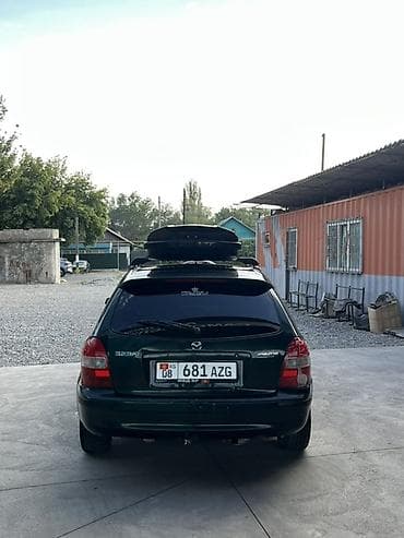 e 303: Mazda 323: 1999 г., 1.6 л, Механика, Бензин, Универсал — 4