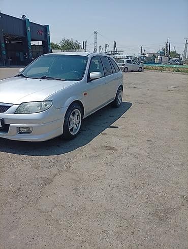 e 302: Mazda Familia: 2003 г., Универсал — 4