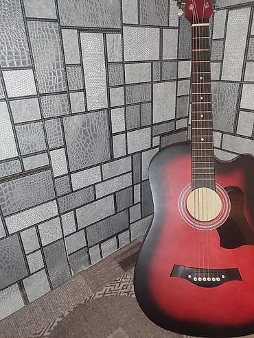 Акустическая гитара, форма корпуса дредноут. Яркий красно‑чёрный