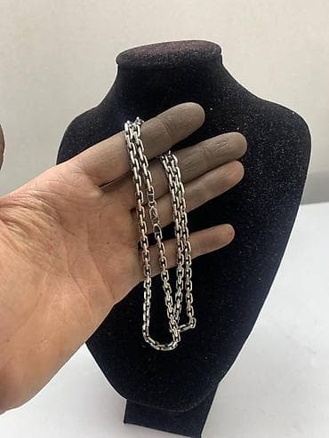 серебряный крестик: Серебряная цепочка Якорь. Вес цепочки составляет 35,2 грамма. Замок — 1