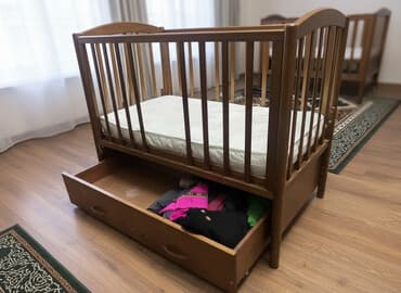 Детская кроватка из массива дерева с маятниковым механизмом и