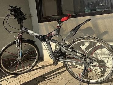 Горный велосипед с двойной подвеской (передний и задний амортизаторы)