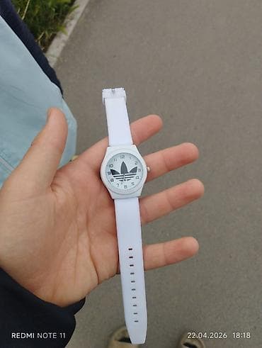 Белые наручные часы с аналоговым циферблатом. Характеристики: -