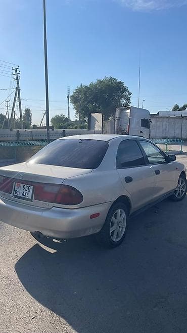 каропка автомат: Mazda 323: 1999 г., 1.5 л, Автомат, Газ, Седан — 7