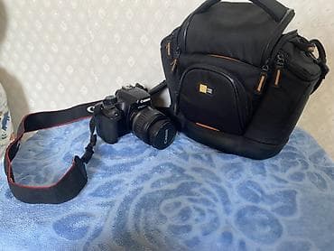 Техника и электроника: Зеркальная камера Canon EOS 1000D с комплектным объективом и сумкой — 1