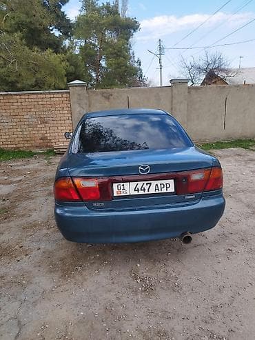 решетка мазда 323: Mazda 323: 1992 г., Седан — 4