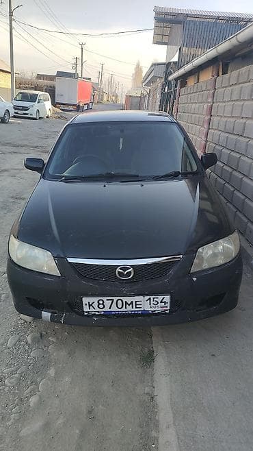 Mazda Familia универсал, черный цвет кузова. Кузов: - Универсал