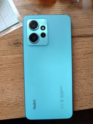 Смартфон Redmi в голубом корпусе, оснащенный несколькими камерами на at lalafo.kg Смартфон Redmi в голубом корпусе, оснащенный несколькими камерами на