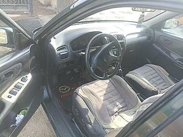 заглушка диска: Mazda Capella: 1998 г., 1.8 л, Механика, Бензин, Универсал — 3