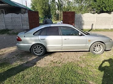керме тоо: Mazda 626: 1999 г., 1.8 л, Кол менен иштөөчү, Бензин, Седан — 3