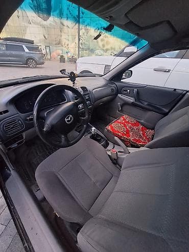 mazda 626 1998: Mazda 323: 2002 г., 1.3 л, Механика, Бензин, Универсал — 5