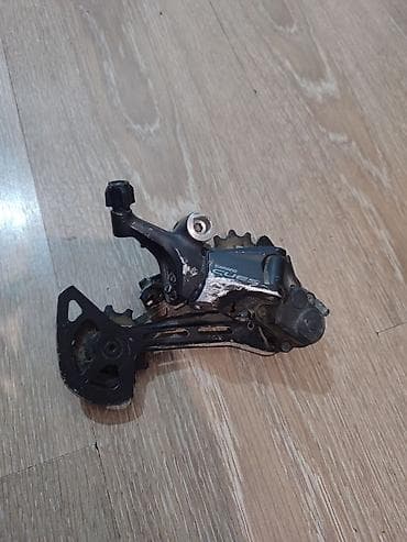 Велокомплект запчастей: 1) Задний переключатель Shimano Cues — тип
