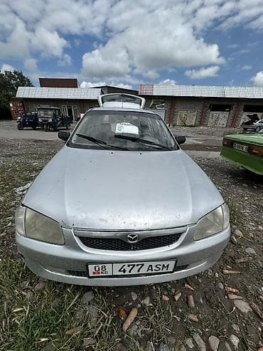 с люком: Mazda 323: 1999 г., Механика, Бензин, Хэтчбэк — 1
