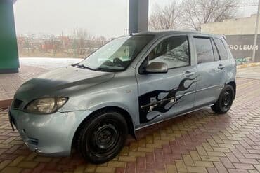 мазда демио передний бампер: Хэтчбек Mazda 2 в светлом оттенке с заметными черными наклейками в — 4