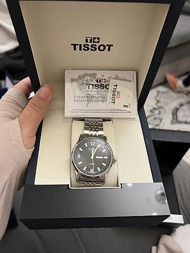 рукова: Наручные часы (2 модели) в фирменных боксах. 1) Tissot, кварцевые: - — 1