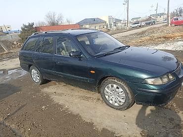 заглушка диска: Mazda Capella: 1998 г., 1.8 л, Механика, Бензин, Универсал — 2