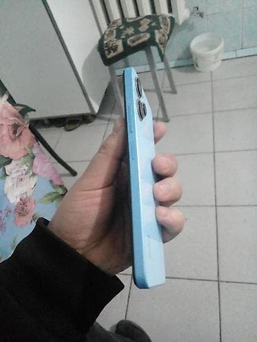 Смартфон в голубом цвете с плоскими гранями и крупным блоком камер