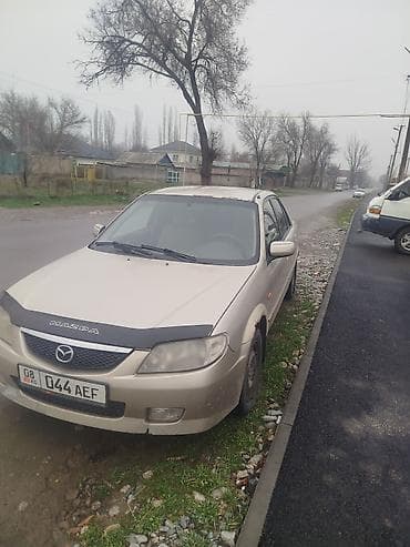Транспорт: Mazda 323: 2001 г., 1.6 л, Кол менен иштөөчү, Бензин, Седан — 1
