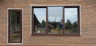 двери на балкон: Комплект из ПВХ двери и трехсекционного окна коричневого цвета. Дверь — 1