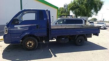 bongo: Kia Bongo III — компактный бортовой грузовик синего цвета. Кузов и — 4