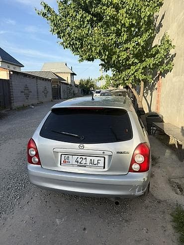 колонка microlab: Mazda 323: 2002 г., 1.6 л, Механика, Бензин, Универсал — 4