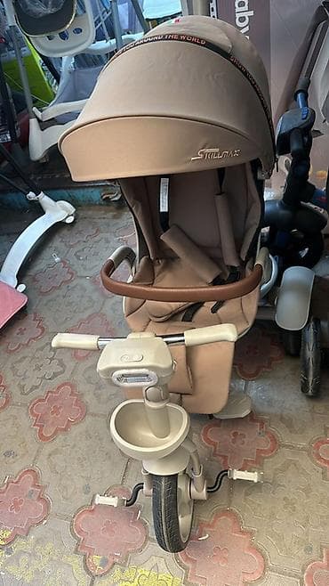 Детский трёхколёсный велосипед-коляска Stillmax с поворотным сиденьем