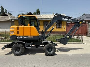 защищённый телефон: Колесный экскаватор Hyundai HW60ECO в желто-серой цветовой гамме — 1