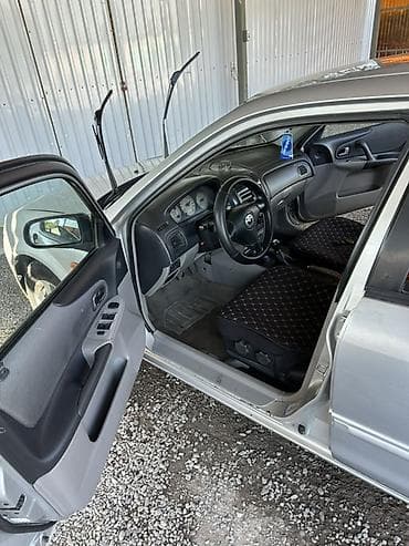 yamaha n max: Mazda 323: 2003 г., 1.6 л, Механика, Бензин, Хэтчбэк — 5