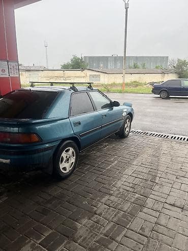 Транспорт: Mazda 323: 1994 г., 1.3 л, Кол менен иштөөчү, Бензин, Хетчбек — 2