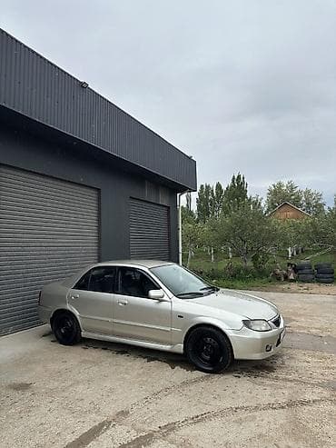 Унаа: Mazda 323: 2002 г., 1.6 л, Кол менен иштөөчү, Бензин, Седан — 7
