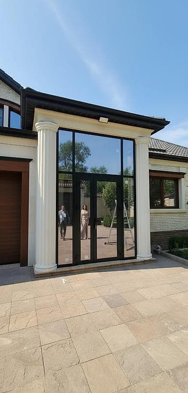 Стеклянная входная дверь с черной рамой, окруженная двумя at lalafo.kg Стеклянная входная дверь с черной рамой, окруженная двумя