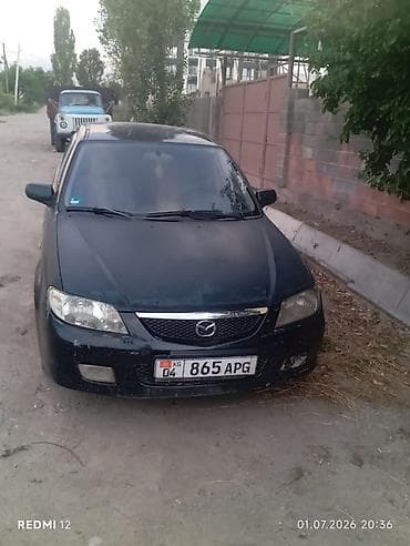 e 303: Mazda Familia: 2003 г., Универсал — 1
