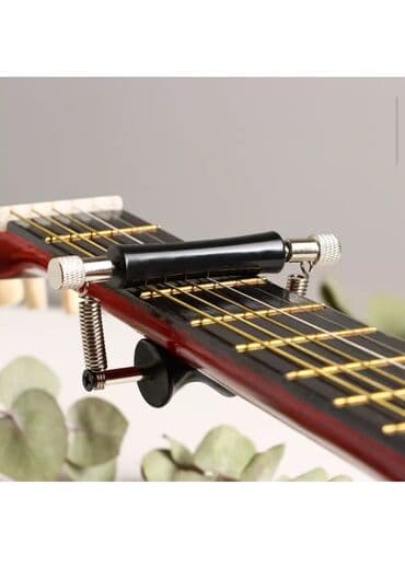 купить струну для гитары: Оригинальные каподастры, универсальные, прочный металл, обмен на — 1