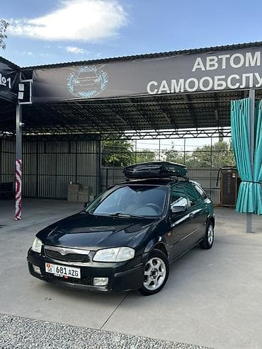 e 303: Mazda 323: 1999 г., 1.6 л, Механика, Бензин, Универсал — 1