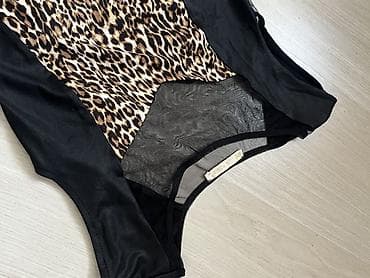 леопардовое платье: Платье с леопардовым принтом и контрастными чёрными вставками. - — 7